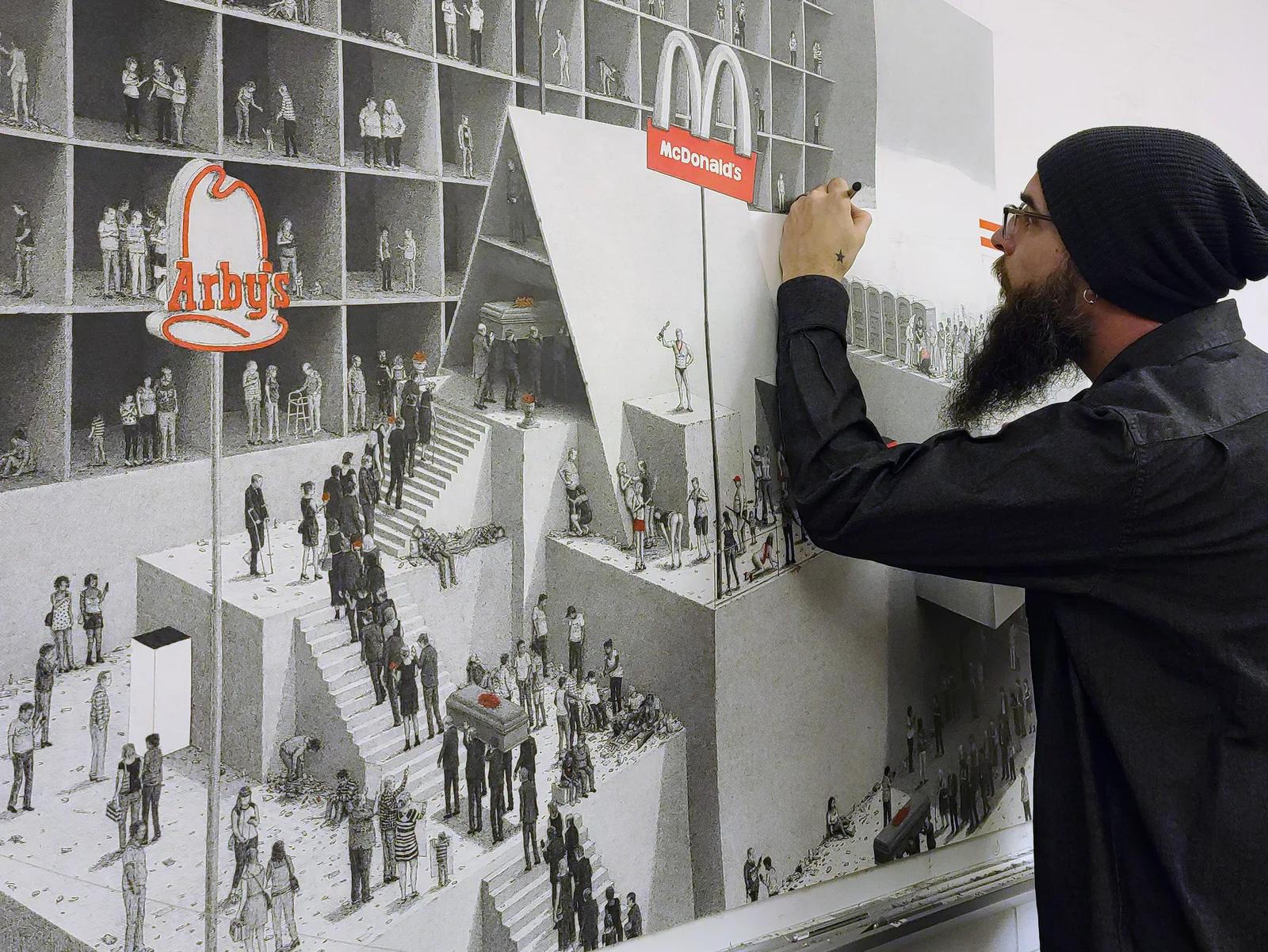 Ben Tolman working on a large-scale ink drawing